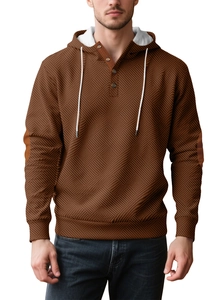 Detail of brown waffle knit hoodie featuring buttoned Henley collar and white lined hood