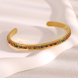 Detail of 18K gold-plated bangle featuring a row of colorful inlaid cubic zirconia stones