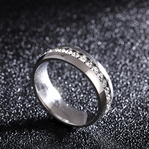 Macro shot of silver 316L stainless steel band ring with embedded clear cubic zirconia