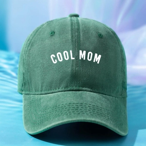 Detail of COOL MOM embroidery on dark green washed cotton baseball cap with curved brim