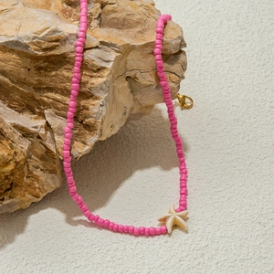 Pink beaded necklace with starfish pendant on a rock, stainless steel jewelry for women