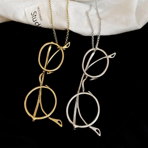 Detailed view of gold and silver eyeglass frame pendants on beaded chains