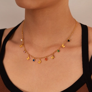 Golden necklace with colorful cubic zirconia and butterfly pendants on female model