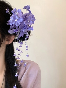 Detailed side view of purple silk lily of the valley hair clip with white pearl tassels