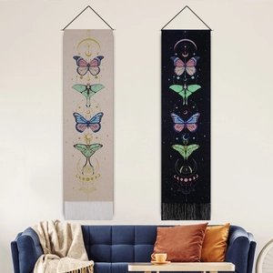 Nordic butterfly canvas tapestries with moon phase and tassels above a sofa