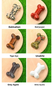 Detailed macro view of six gemstone bone carvings including tiger eye and red jasper