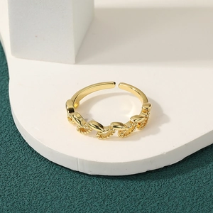 Close-up of gold plated adjustable ring featuring openwork chain texture and bead details