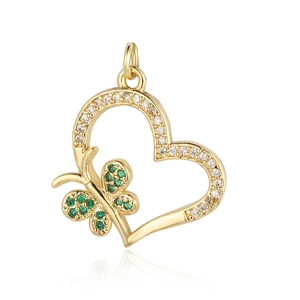 Macro view of gold heart pendant with green butterfly and clear cubic zirconia stones