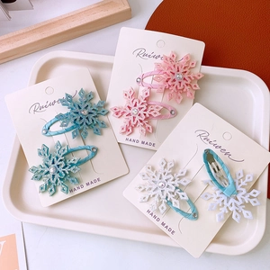 Sweet snowflake hair clips for kids with glitter coating and sparkling rhinestones