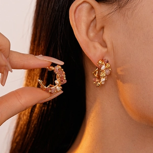 Sweet strawberry quartz and pearl C-shaped gold earrings shown on a model
