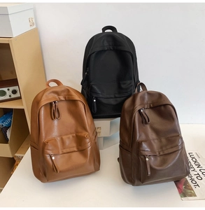 Retro soft leather backpacks shown in black, brown and caramel colors in a studio setting