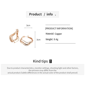 Detail view of irregular wavy copper earrings in rose gold with 3cm dimension markers