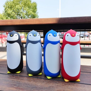 Group of cute penguin-shaped insulated glass water bottles in four vibrant colors