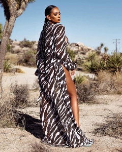 Detail of long zebra print beach cover-up with waist tie and side slits in desert light