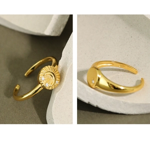Close-up of S925 sterling silver gold ring featuring micro-inset zircons on a round relief