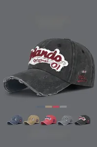 Close-up of vintage washed denim baseball caps with distressed embroidery and patches