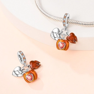 Detail of silver owl charm with 'give thanks' heart, pumpkin, and brown leaf pendants