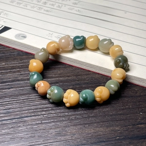 Detail view of colorful Bodhi root cat paw beads on a traditional wooden background