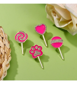 Pink enamel lollipop and cat paw pins with sparkling rhinestones and gold-plated borders