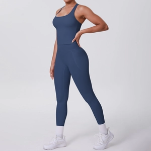 Detail view of high-waist blue yoga leggings with side pocket and matching tank top set