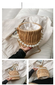 Detailed view of round woven straw bag with pearl handle and golden chain strap