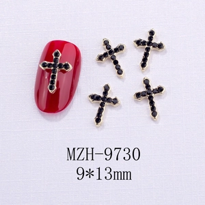 Dettaglio charm per unghie a croce con strass neri su unghia rossa di manichino