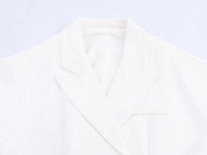 Detail of the white linen blend blazer featuring crisp notched lapels and twill texture