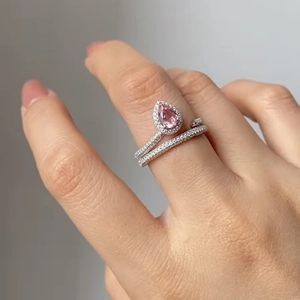 Double band silver ring featuring a pear-cut pink gemstone and pavé-set clear crystals