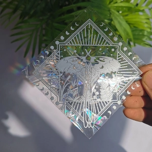 Detailed holographic suncatcher sticker featuring a geometric moth and moon design