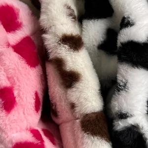 Plush heart pattern and cow print faux fur bucket hat available in pink and white