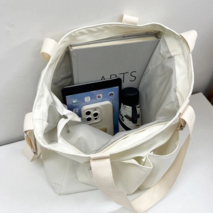 Off-white large capacity waterproof canvas tote bag with adjustable strap and inner pockets