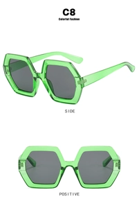 Detail view of model C8 oversized hexagonal green sunglasses with dark grey lenses