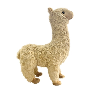 Cute fluffy light brown alpaca plush toy standing in center on white background