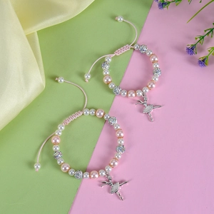 Detail of adjustable ballet girl charm bracelets with faux pearls and rhinestone balls