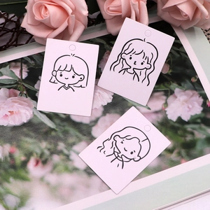 Detailed view of three pink earring display cards featuring cute black line girl illustrations
