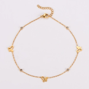Detailed shot of golden butterfly anklet with sparkling round crystals and lobster clasp