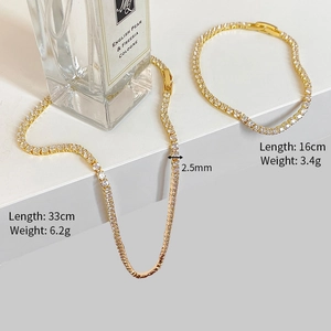 Detailed view of gold tennis necklace and bracelet set with dimensions 33cm and 16cm
