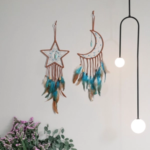 Dreamcatcher wall decor with moon and star shapes featuring turquoise and feathers