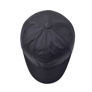 Top-down macro view of a black short brim cotton baseball cap with six-panel crown