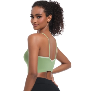 Detail of light green seamless sports bra with cross back straps and deep V-neck design