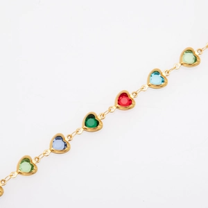 Detail of gold-plated chain bracelet featuring heart-shaped links with colorful gemstones