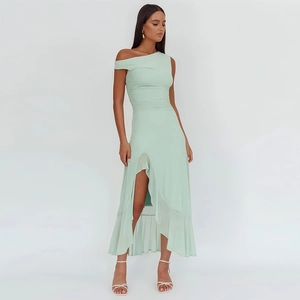 Close-up of elegant light green off-shoulder dress with a stylish high slit detail