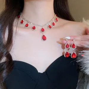 Elegant silver jewelry set featuring red teardrop gemstones and necklace with earrings