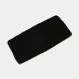 Detail shot of the black ribbed knit headband showing soft fabric texture and weave
