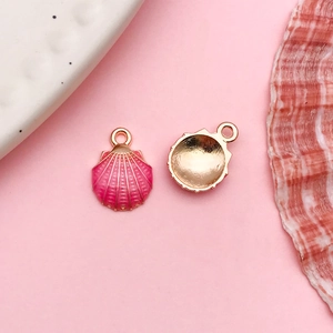 Front and back view of pink enamel shell pendants with golden alloy frames for DIY jewelry