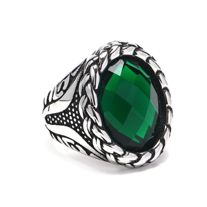 Vintage braided stainless steel ring featuring a large oval faceted green gemstone inlay