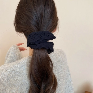 Close-up of black double-layered hollow lace scrunchie worn on a high ponytail