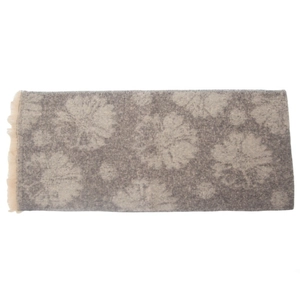 Detailed close-up of grey and beige floral jacquard scarf with decorative fringe edges