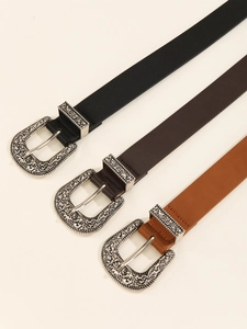 Detailed close-up of retro engraved silver buckles on black, brown, and camel belts