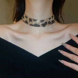 Close-up of sparkling leopard print choker necklace with diamonds on female model